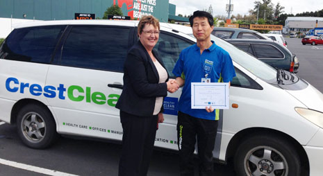 CrestClean Auckland North Shore Regional Manager Caroline Wedding presenting Martin with his 10 year certificate