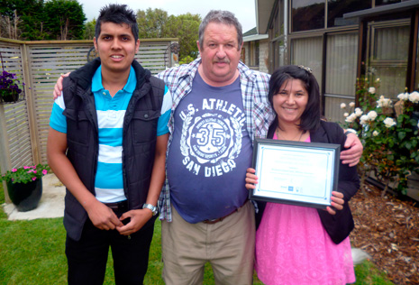 Invercargill Crest Regional Manager Glenn Cockroft presents the certificate for Invercargill's Franchisee of the Year 2013 to Richard Chand and Akhtar Juanmiry.