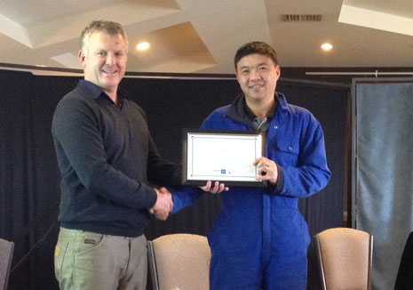 Tianlei Fu receiving his 5 Years Long Service Award from Grant McLauchlan.