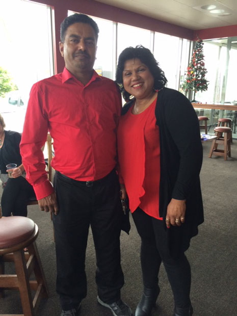Birendra and Lakshmi Kumar looking festive in matching red shirts. 