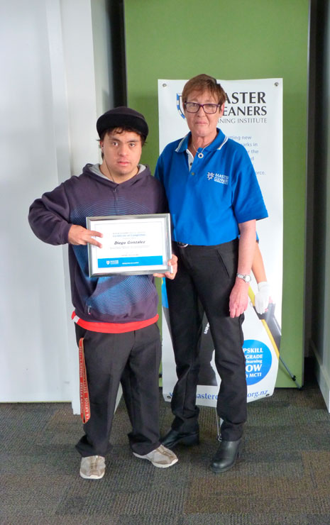 Diego Gonzalez, of MacLaren Park Henderson South Community Trust, received a certificate of completion from the Master Cleaners Training Institute. Diego is pictured with Auckland Operations Coordinator Julie Griffin.