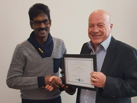 Keshwan receives his seven-year Long Service Certificate from Wellington Regional Manager Richard Brodie.
