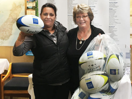 Barbara de Vries (right), Crest’s Nelson Regional Manager, presents rugby balls to Janice Gulbransen, Principal of Nayland Primary School, Nelson.