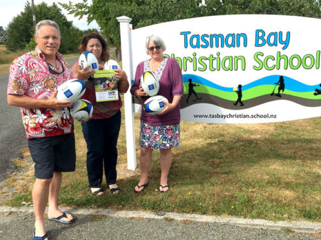 Craig Starrenburg and Judy-Anne Sunby receive the rugby balls from Barbara de Vries, CrestClean’s Nelson Regional Manager.