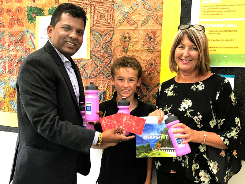 Angela Smith, Principal, receives prizes for the Mauku Fun Run from CrestClean’s Viky Narayan. Looking on is pupil Jaxon McMurtrie