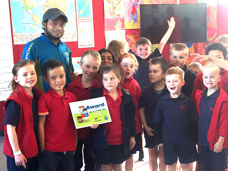 Aznayne Ali hands out the Cleanest Classroom Award at Milson School, Palmerston North.