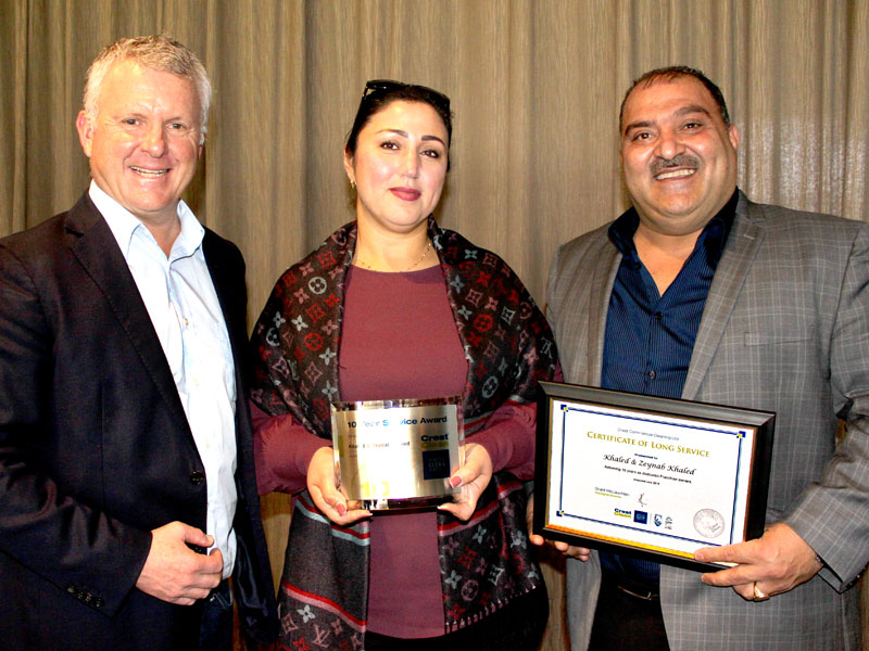 Zeynab and Khaled Khaled receive their long service award from Grant McLauchlan, CrestClean’s managing director.