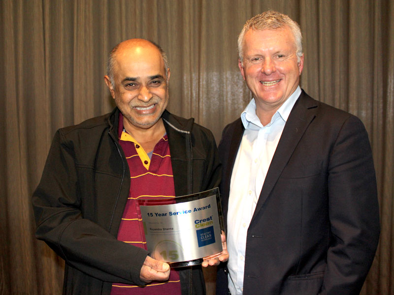 Rupendra Sharma receives his 15 Year Service Award from CrestClean’s Grant McLauchlan.