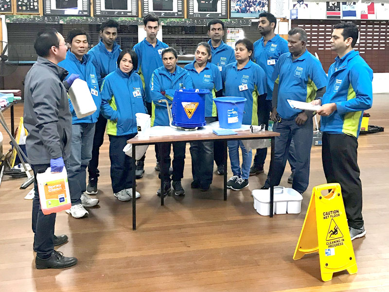 Jason Cheng (left) and Pinakin Patel with CrestClean personnel attending the training event run by the Master Cleaners Training Institute.