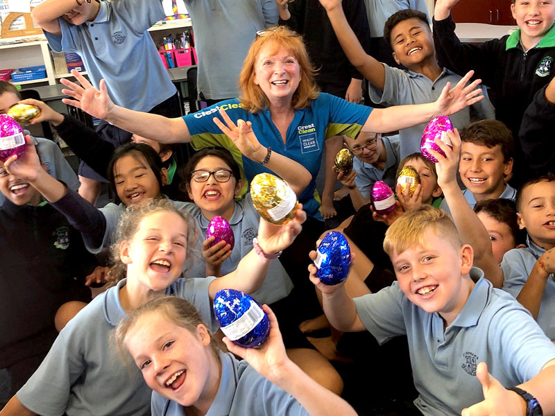 Deborah Herries hands out Easter eggs to children who won the Cleanest Classroom competition at St Patrick’s School, Napier. 