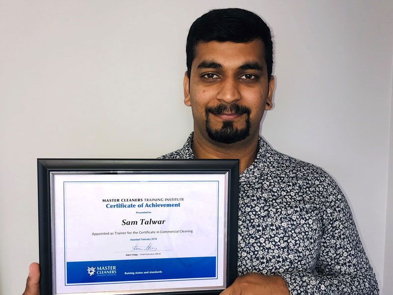 Sam Talwar with his certificate from Master Cleaners Training Institute.