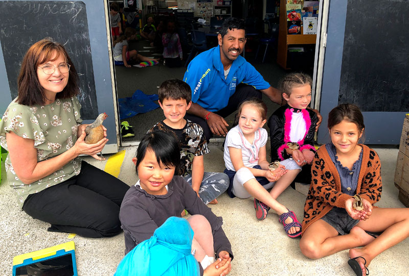 Salendra Chetty with teacher Suzie Gray and students at Maunu Primary School.