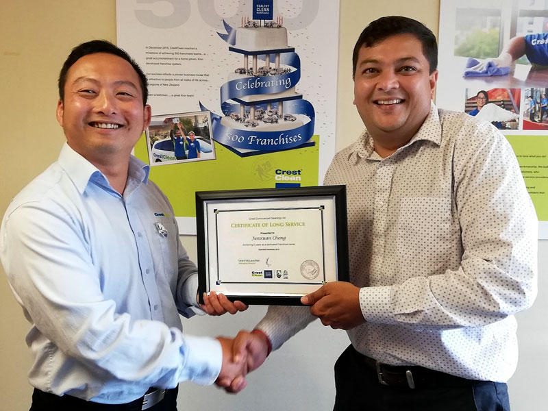 Jason Cheng receives his long service award from Nivitesh Kumar, CrestClean’s Waikato Regional Manager.