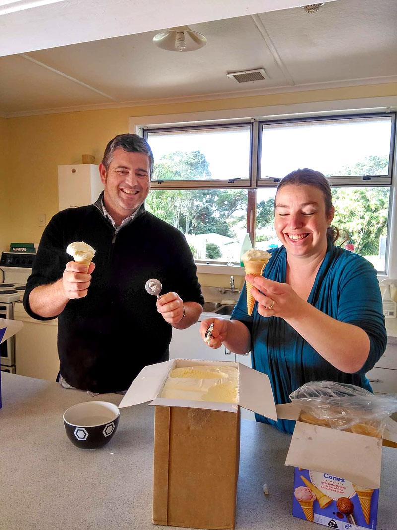 Hamish Hislop and school support worker Emma Warren prepare ice cream for kids at Moturoa School. 
