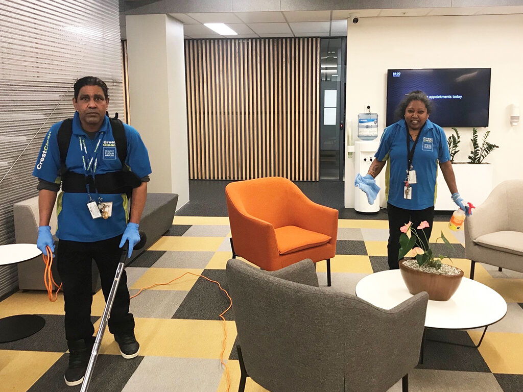 Cleaners cleaning an office space.