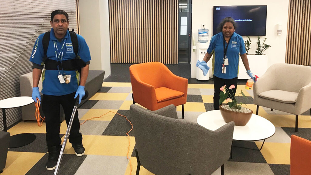 Cleaners cleaning an office space.