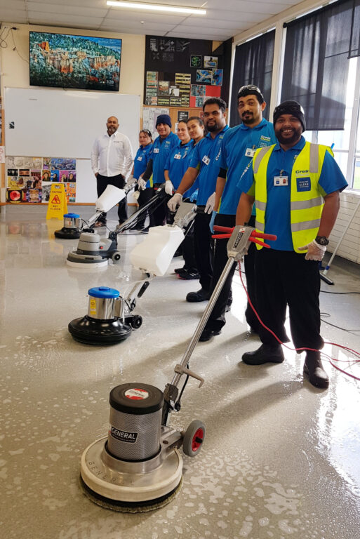 A line up of cleaners with floor cleaning machines.