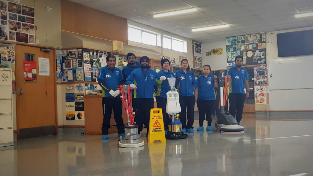 Cleaners with their floor cleaning machines.