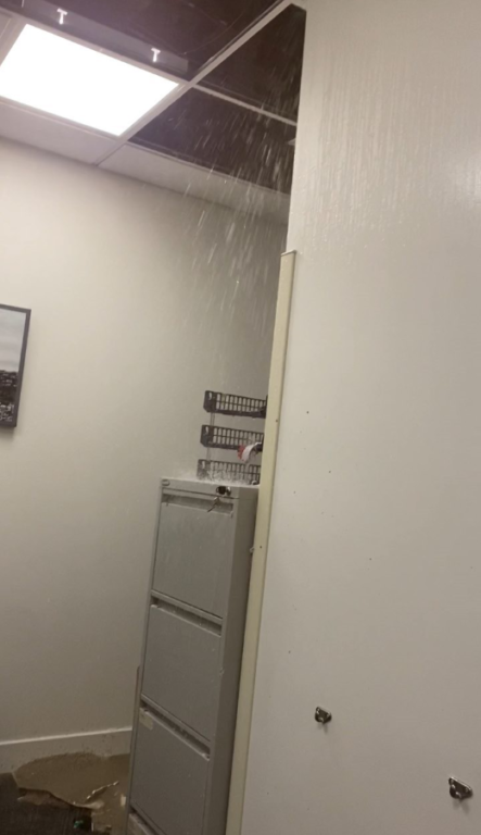Water pouring from the ceiling.