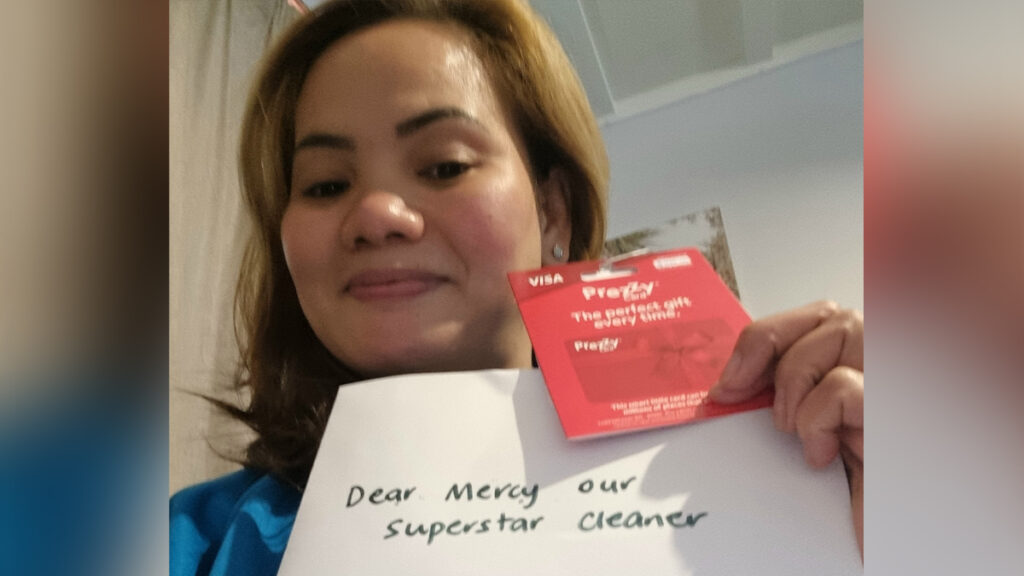 Cleaner holding Christmas card.