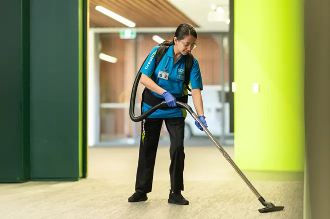 Cleaning hallway with vacuum cleaner