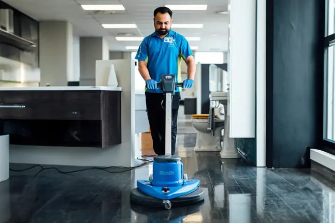Man cleaning retail hard floor with polisher